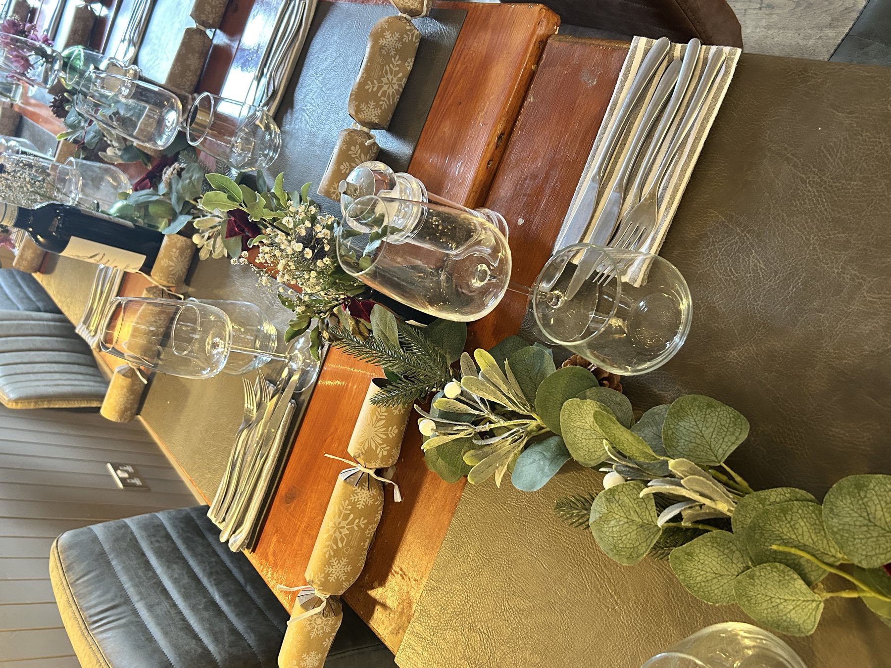 A Christmas garland and crackers running down a laid table at The Russell Arms
