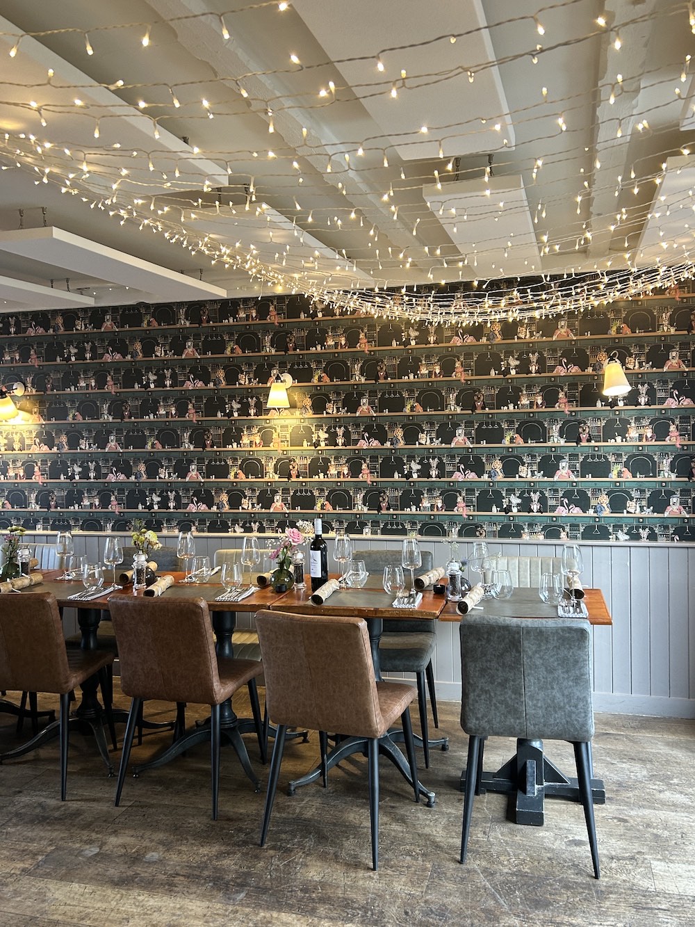 The restaurant set up for a private party, with Christmas lights strung above the tables