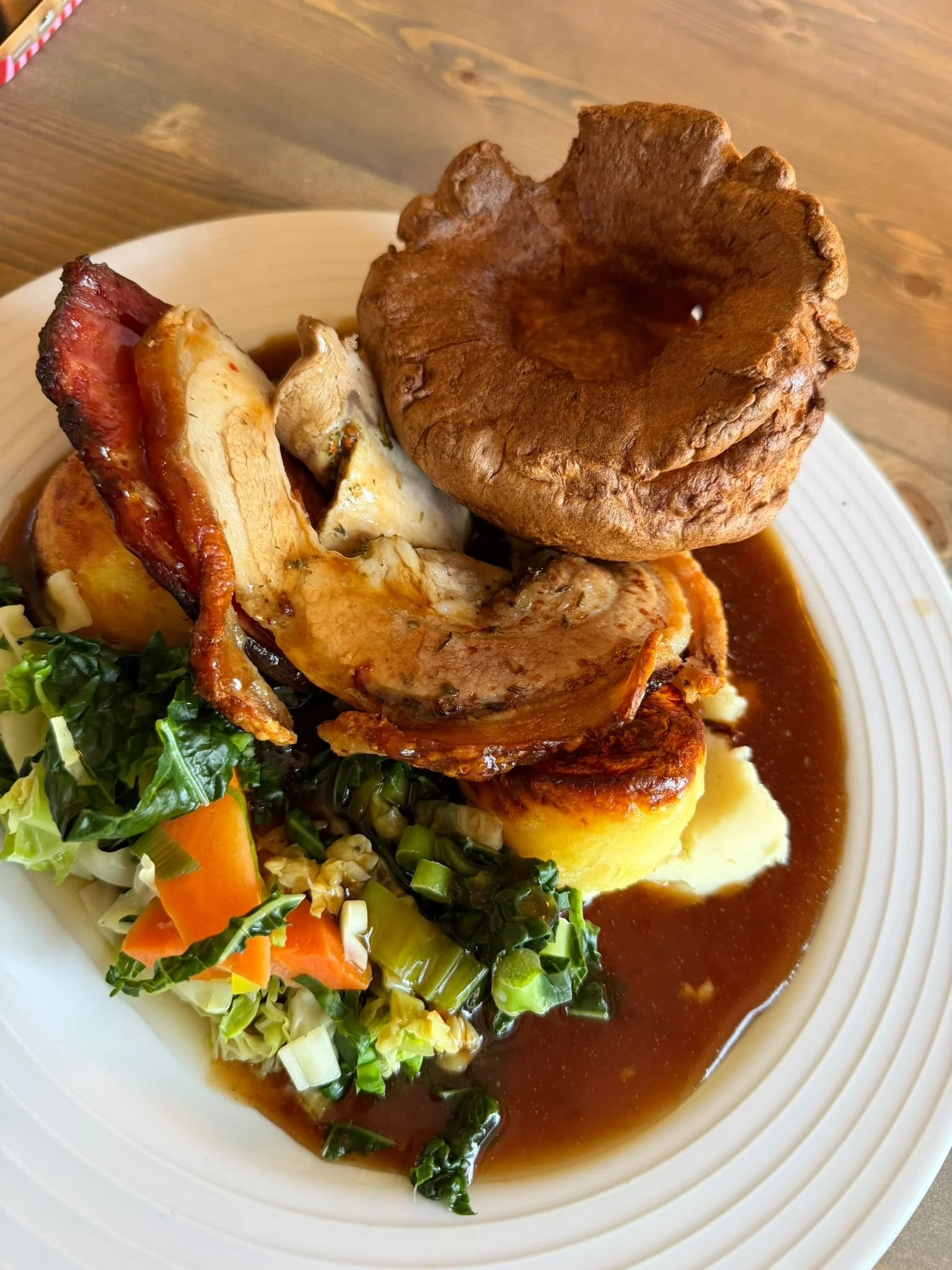 A Sunday roast at The Russell Arms with a Yorkshire pudding, greens and gravy